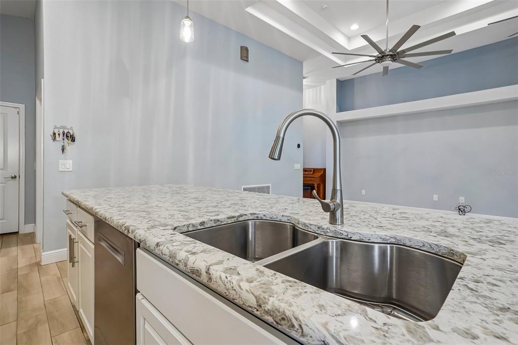 10339 Addison Shore Way Oxford, FL 34484 - Photo 33 of 54 a kitchen with a sink cabinets a counter top space and stainless steel appliances
