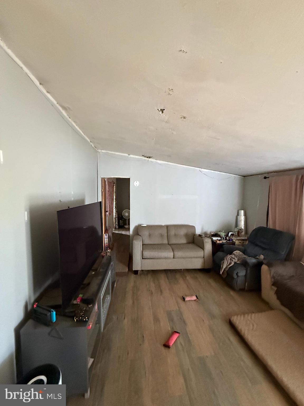 2418 Seeneytown Road Dover, DE 19904 - Photo 15 of 20 a living room with furniture and a flat screen tv