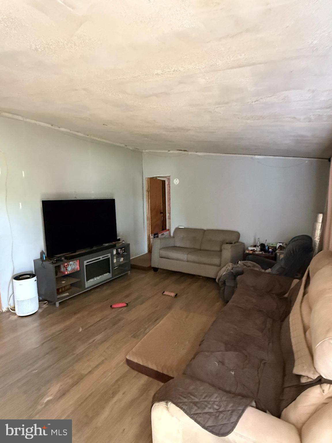 2418 Seeneytown Road Dover, DE 19904 - Photo 16 of 20 a living room with furniture and a flat screen tv