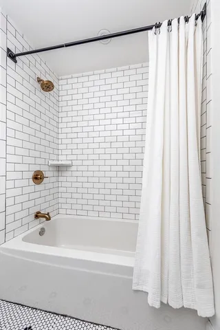 a bathroom with a bathtub and a shower