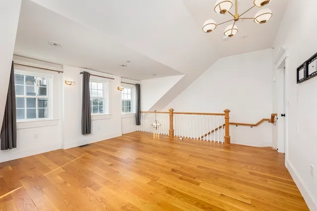 a bedroom with a bed and large windows