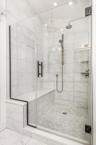 a bathroom with a glass shower door