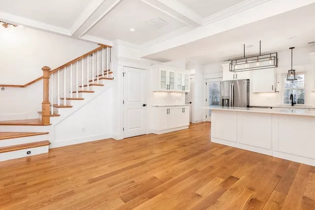 a view of a kitchen with wooden floor and electronic appliances