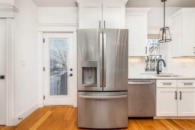 a kitchen with stainless steel appliances a refrigerator and a stove