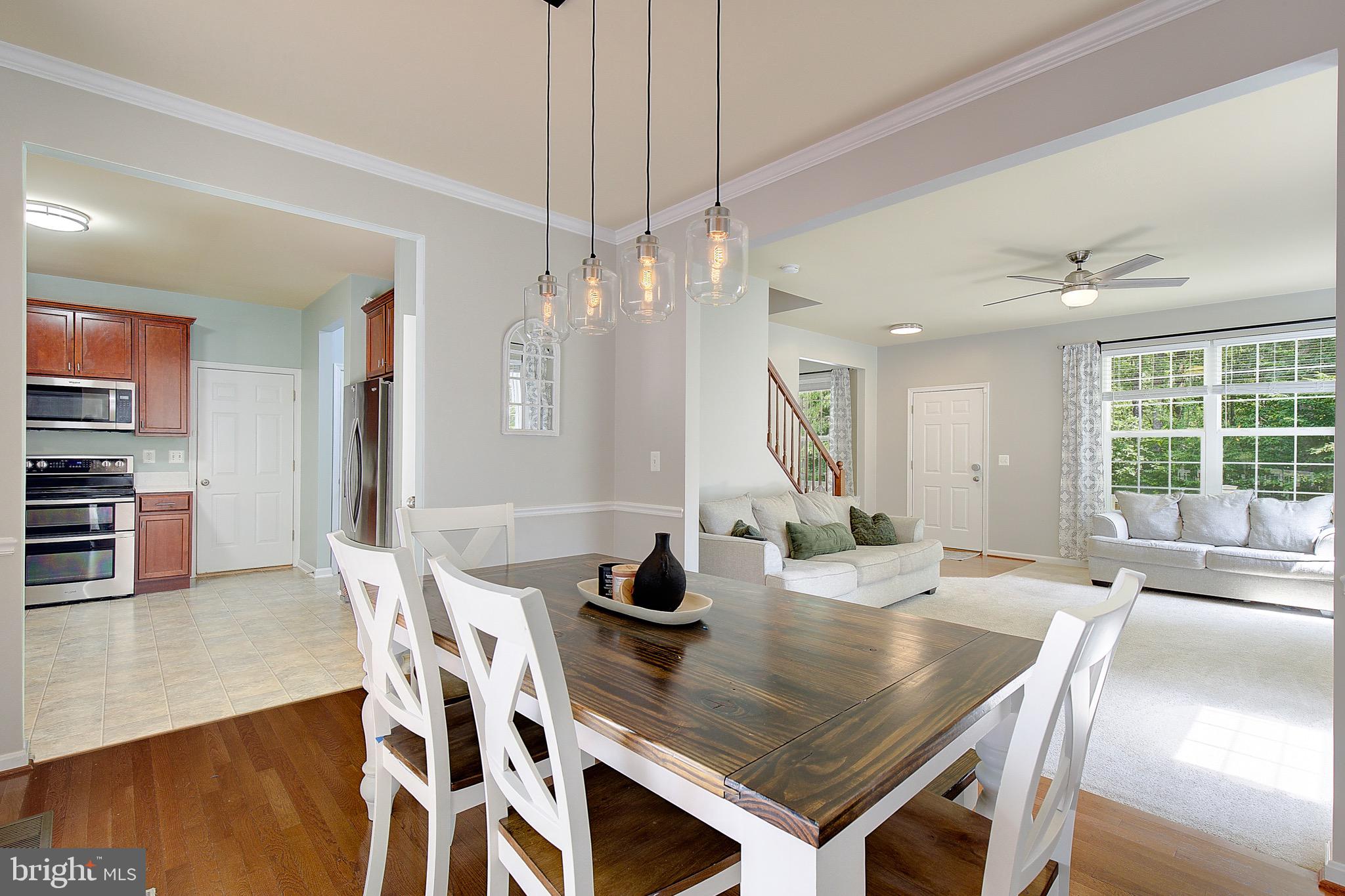 650 Stratton Place Prince Frederick, MD 20678 - Photo 11 of 51 a room with stainless steel appliances a table and chairs in it