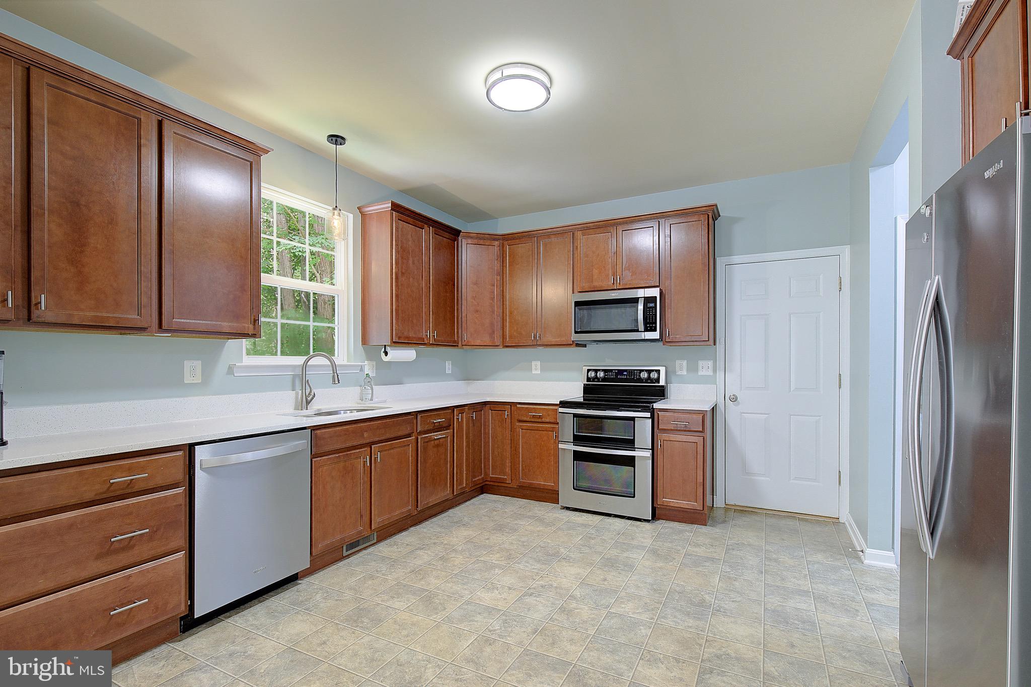 650 Stratton Place Prince Frederick, MD 20678 - Photo 13 of 51 a kitchen with stainless steel appliances granite countertop a refrigerator a stove top oven a sink and dishwasher