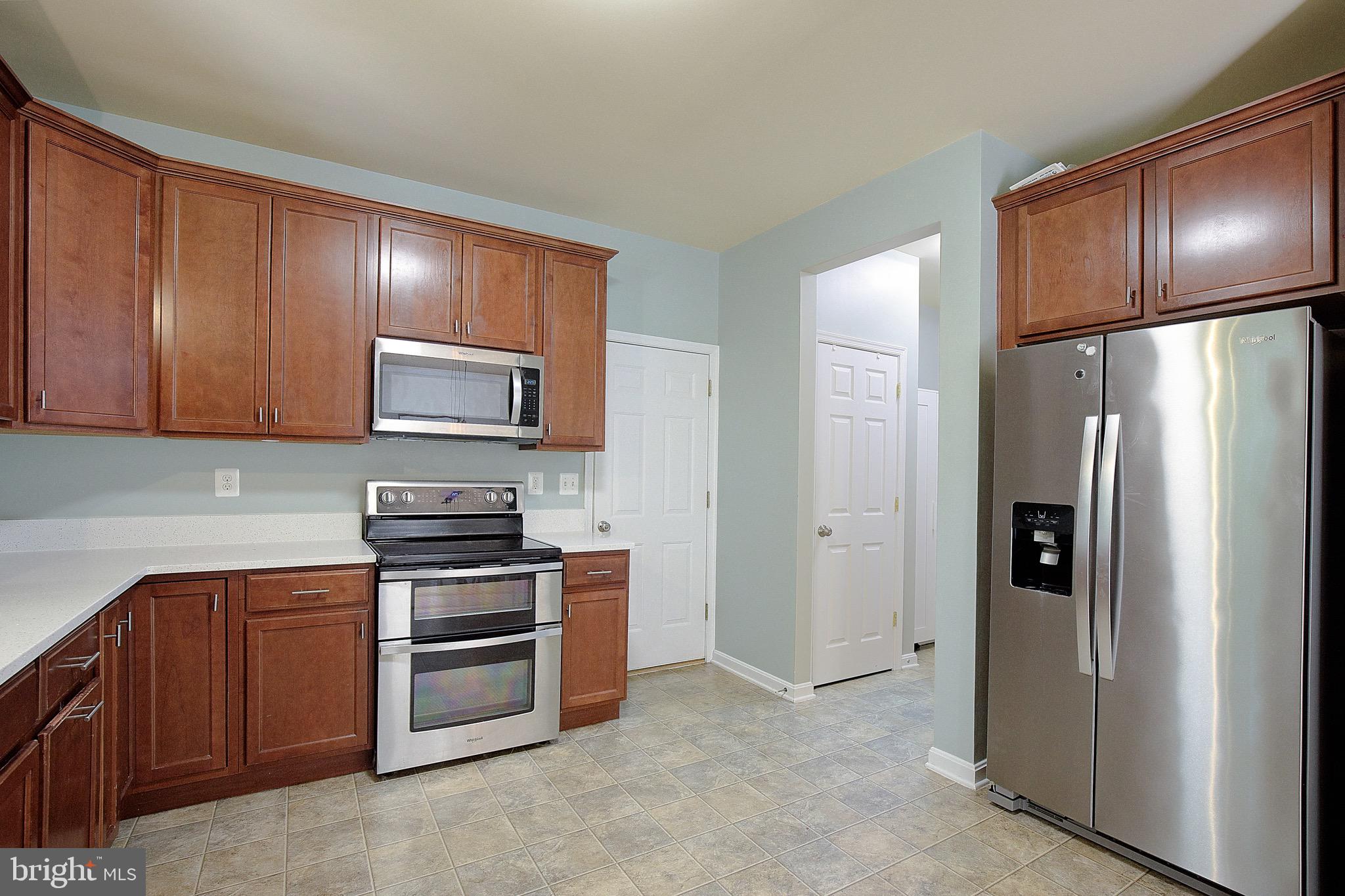 650 Stratton Place Prince Frederick, MD 20678 - Photo 14 of 51 a kitchen with stainless steel appliances granite countertop a refrigerator stove and microwave