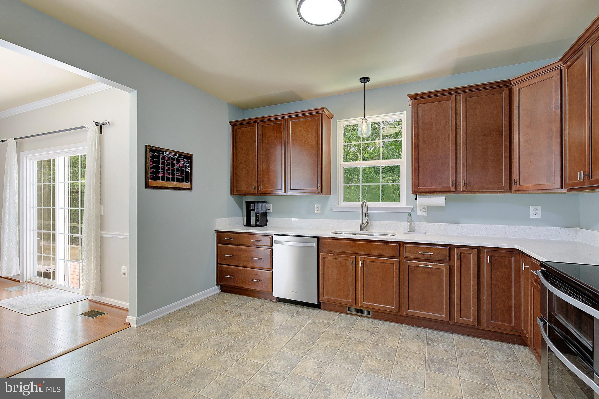 650 Stratton Place Prince Frederick, MD 20678 - Photo 17 of 51 a kitchen with stainless steel appliances granite countertop wooden cabinets a sink and a large window