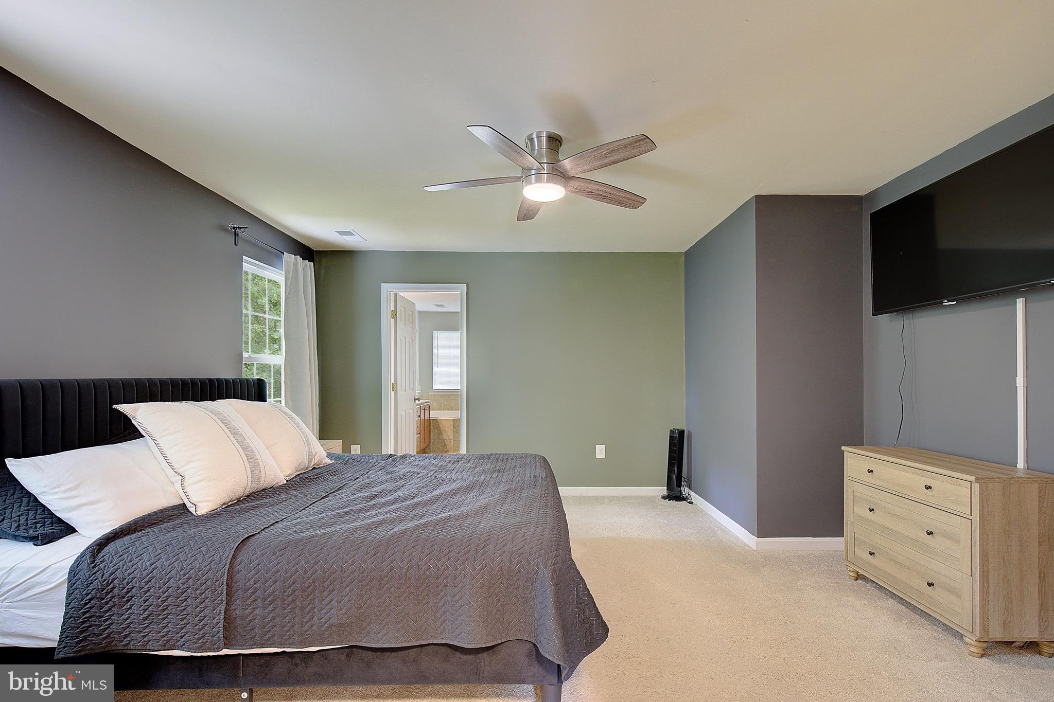 650 Stratton Place Prince Frederick, MD 20678 - Photo 26 of 51 a bedroom with a bed and a flat screen tv