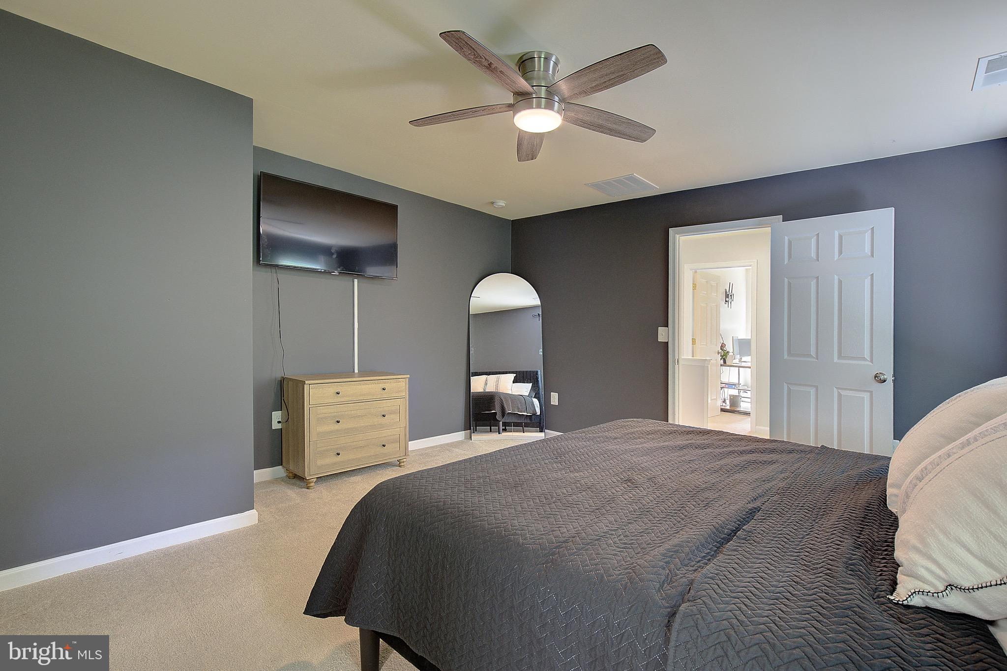 650 Stratton Place Prince Frederick, MD 20678 - Photo 28 of 51 a bedroom with a bed and a chandelier