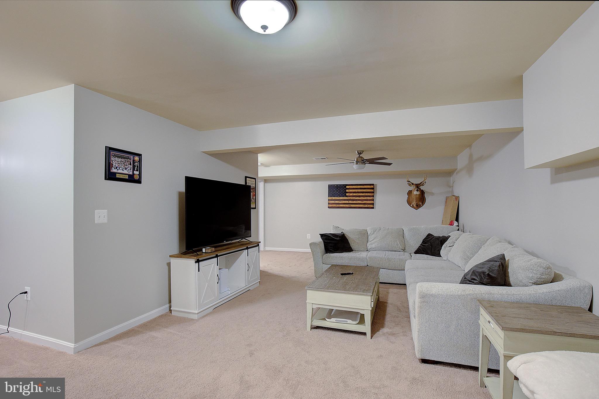 650 Stratton Place Prince Frederick, MD 20678 - Photo 35 of 51 a living room with furniture and a flat screen tv