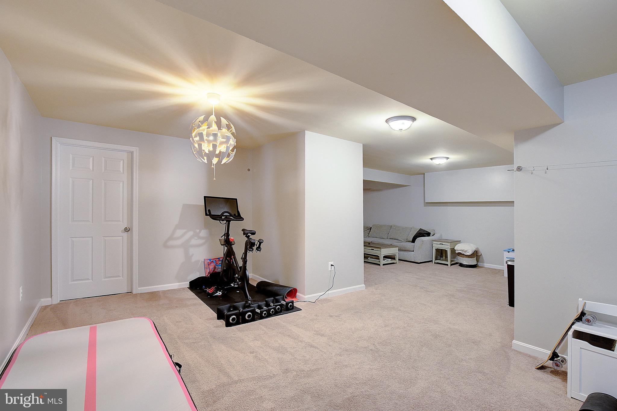 650 Stratton Place Prince Frederick, MD 20678 - Photo 38 of 51 a bedroom with a bed and a chandelier