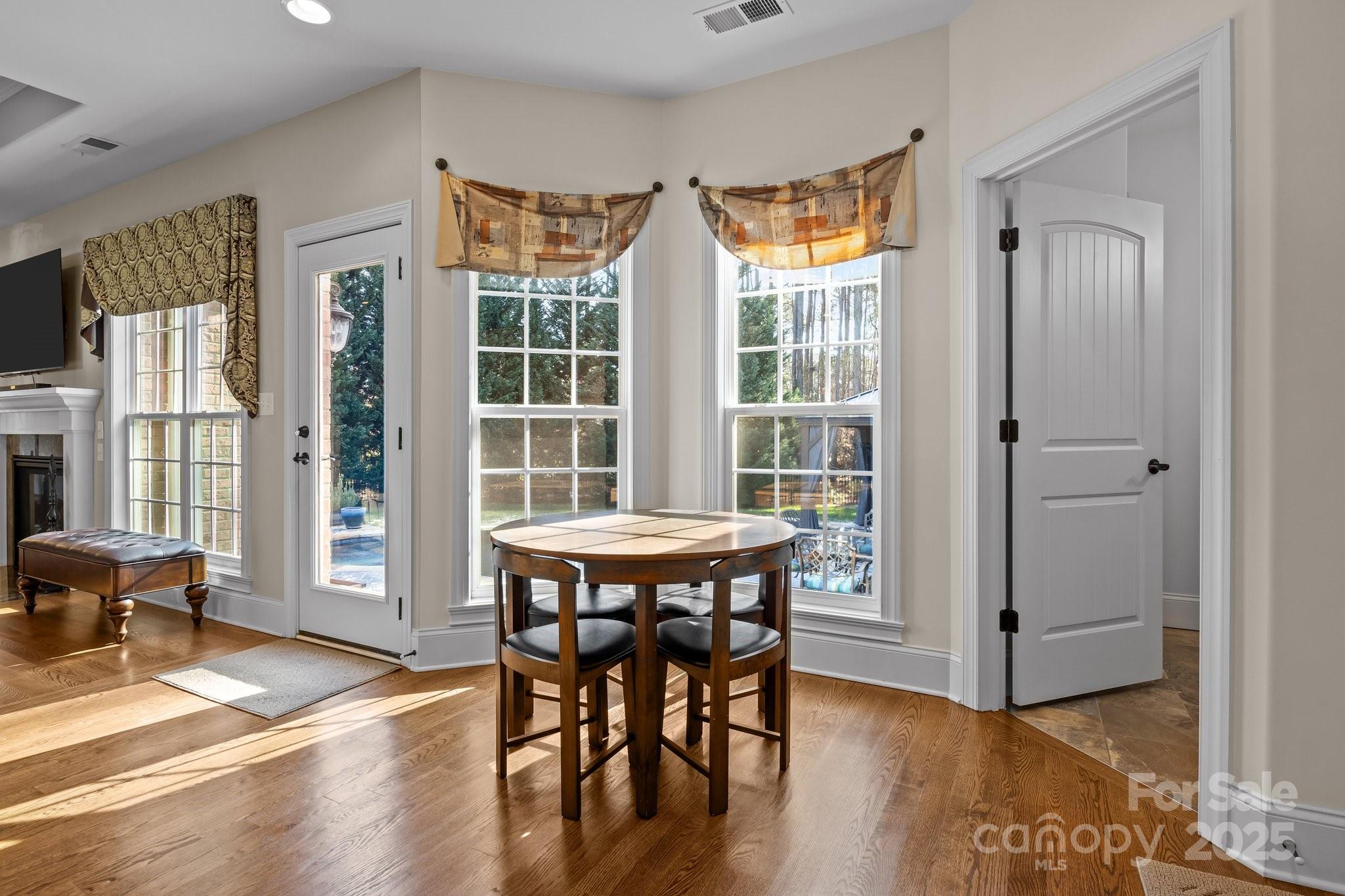 574 Barber Loop Mooresville, NC 28117 - Photo 12 of 34 a view of a dining room with furniture window and wooden floor
