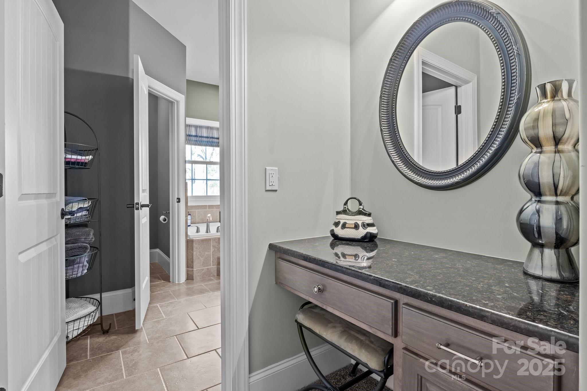 574 Barber Loop Mooresville, NC 28117 - Photo 15 of 34 a bathroom with a granite countertop toilet a sink and mirror