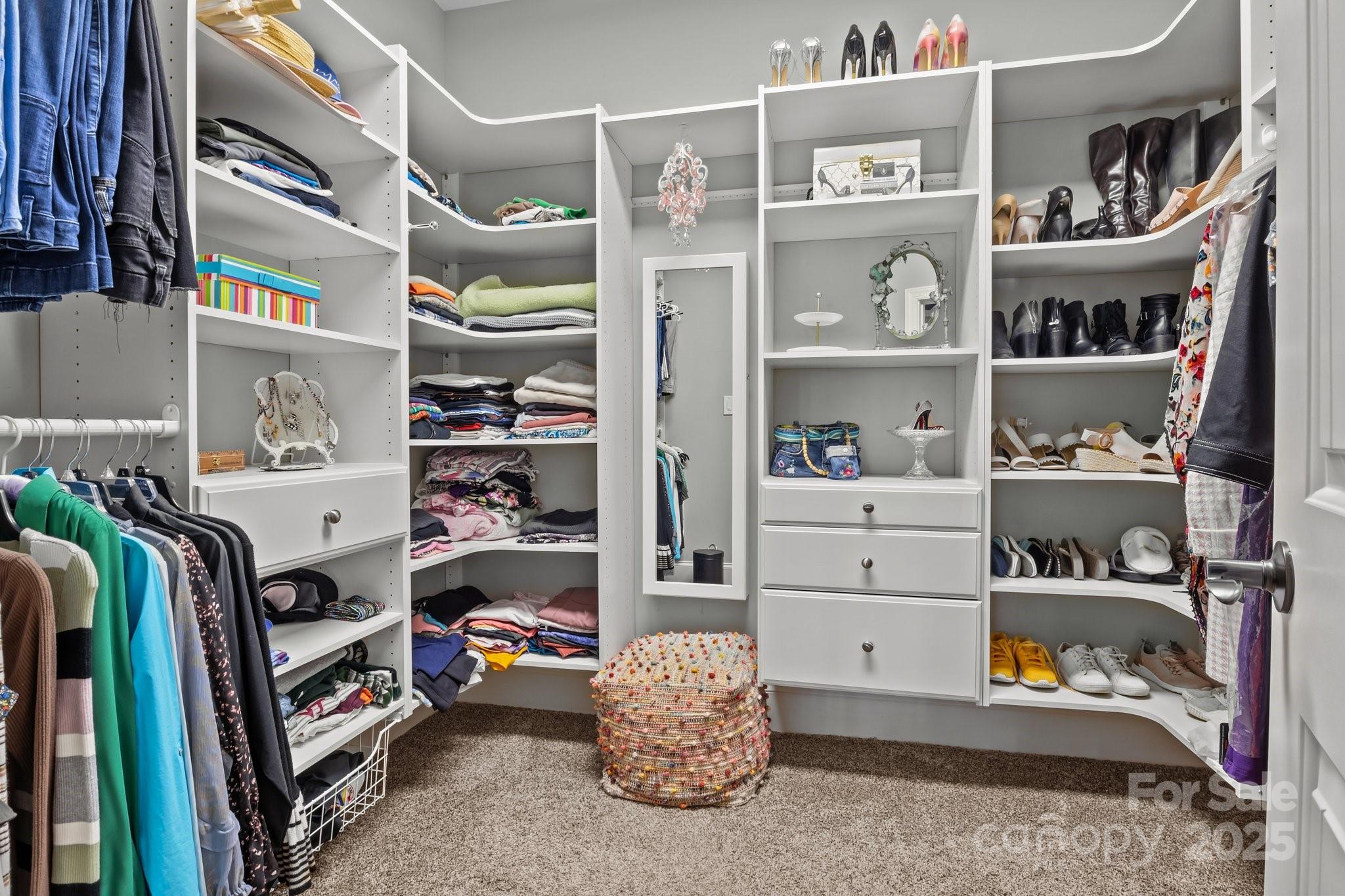 574 Barber Loop Mooresville, NC 28117 - Photo 18 of 34 a view of walk in closet with clothes and shoes