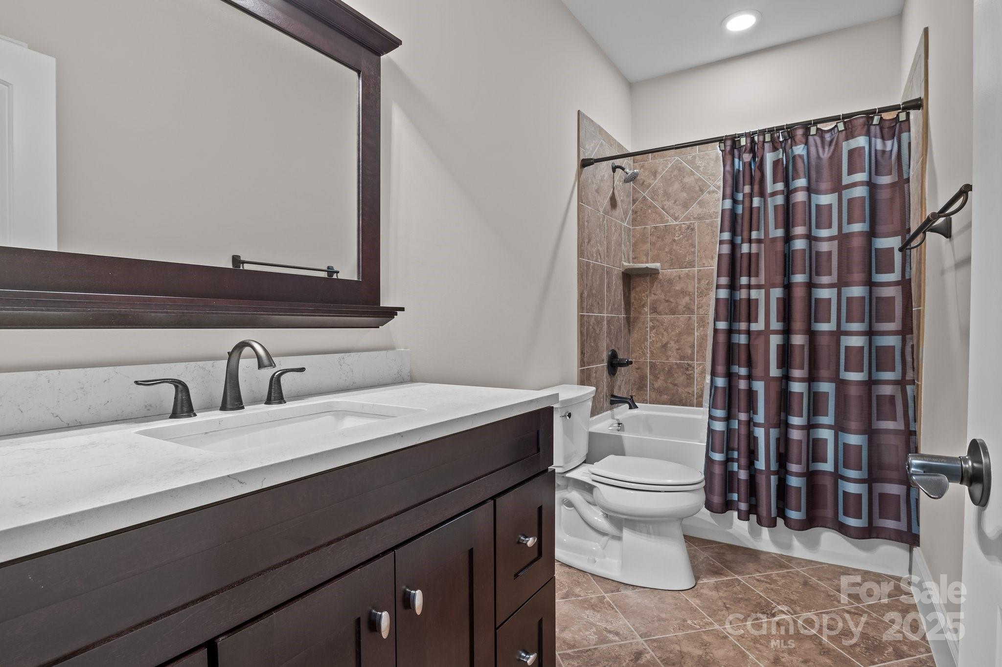 574 Barber Loop Mooresville, NC 28117 - Photo 20 of 34 a bathroom with a sink a toilet and shower