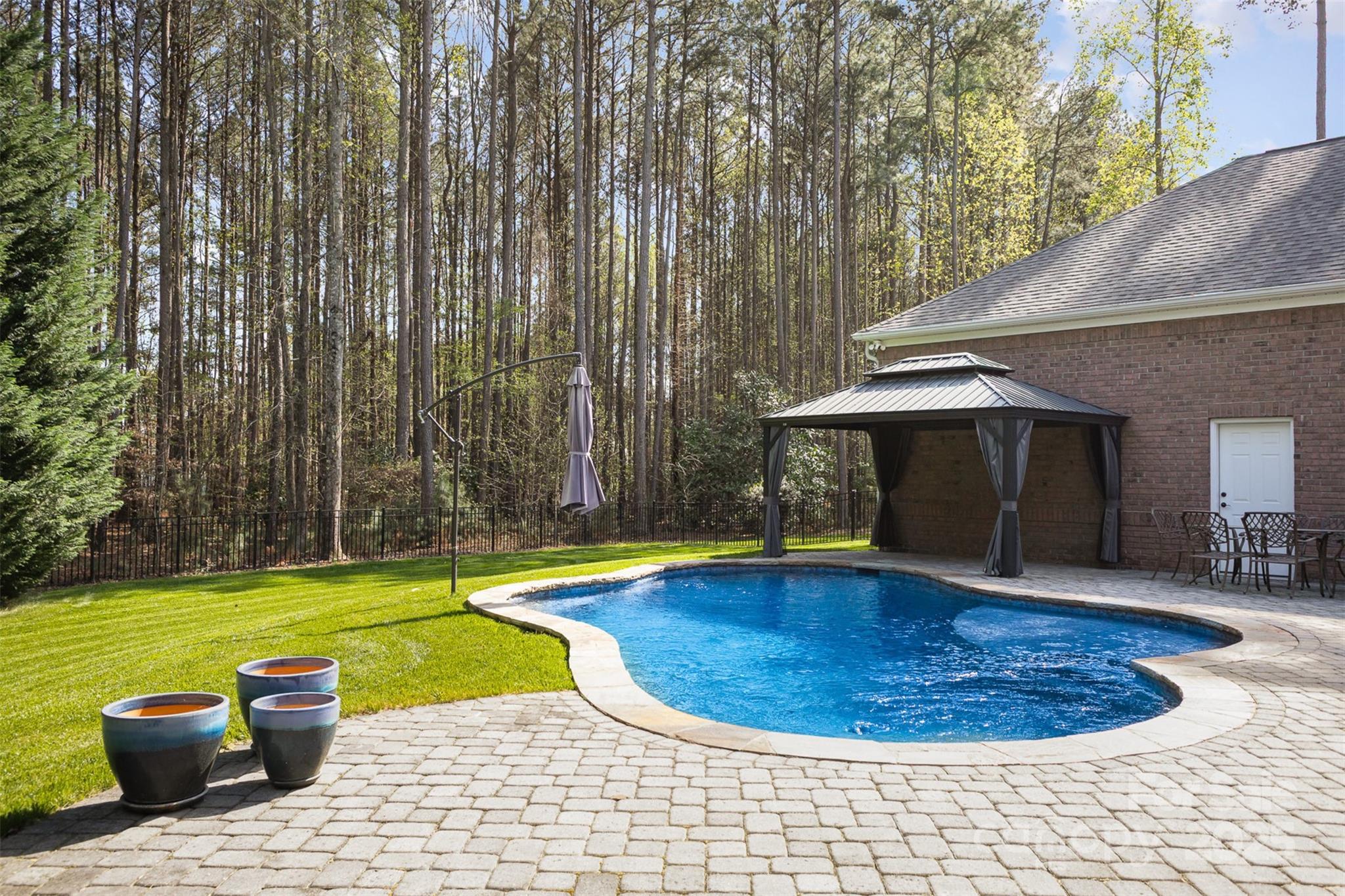 574 Barber Loop Mooresville, NC 28117 - Photo 25 of 34 a view of a swimming pool with a patio