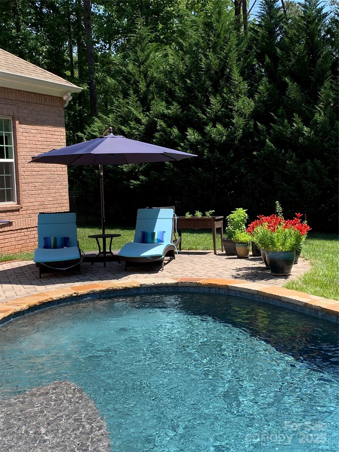 574 Barber Loop Mooresville, NC 28117 - Photo 28 of 34 a view of pool table and chairs under an umbrella