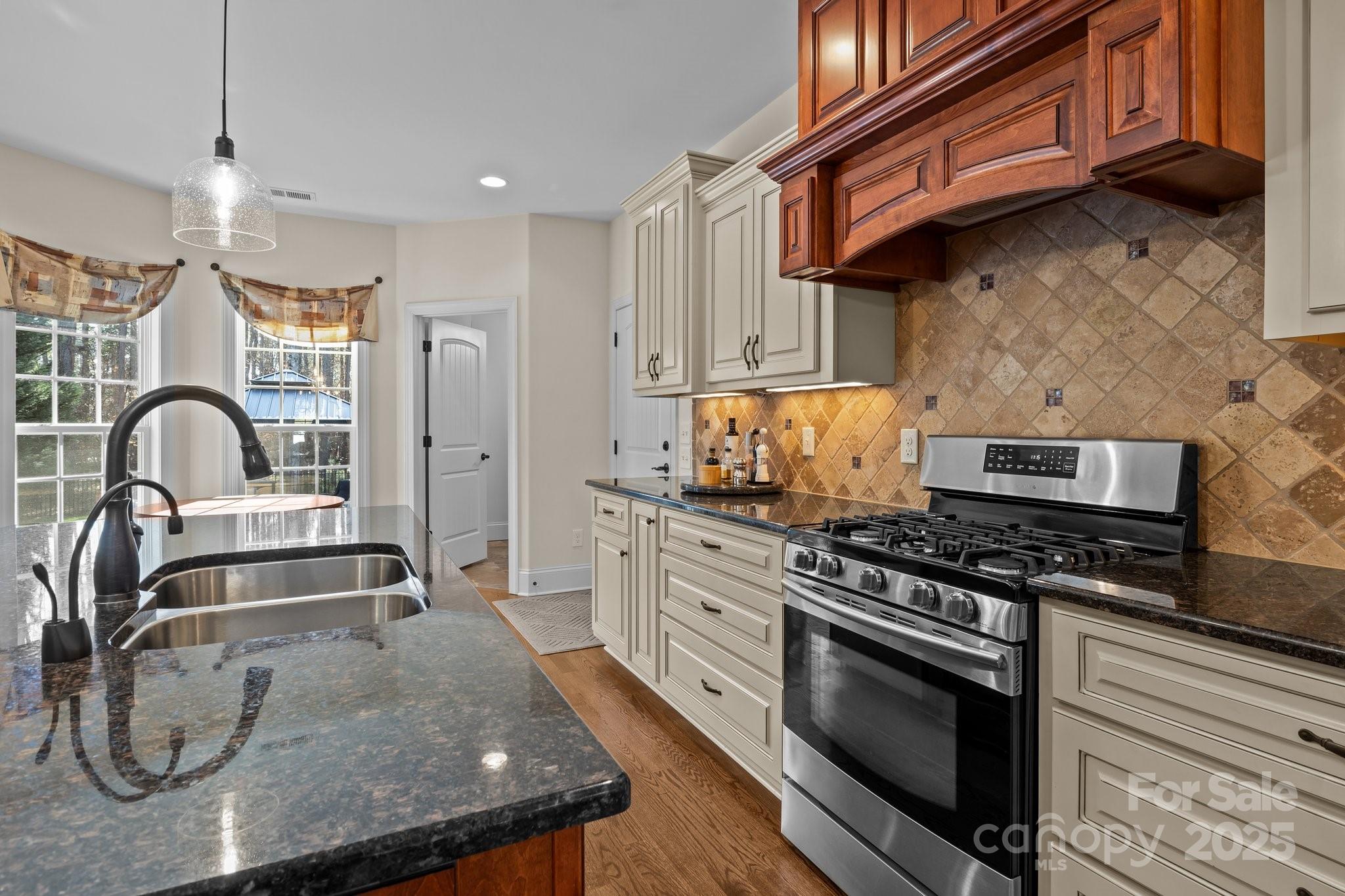 574 Barber Loop Mooresville, NC 28117 - Photo 9 of 34 a kitchen with granite countertop a stove and a sink