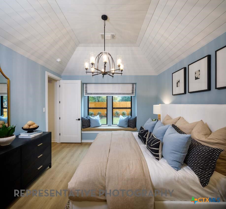 8808 Fallkill Drive Austin, TX 78744 - Photo 14 of 34 a spacious bedroom with a bed and window