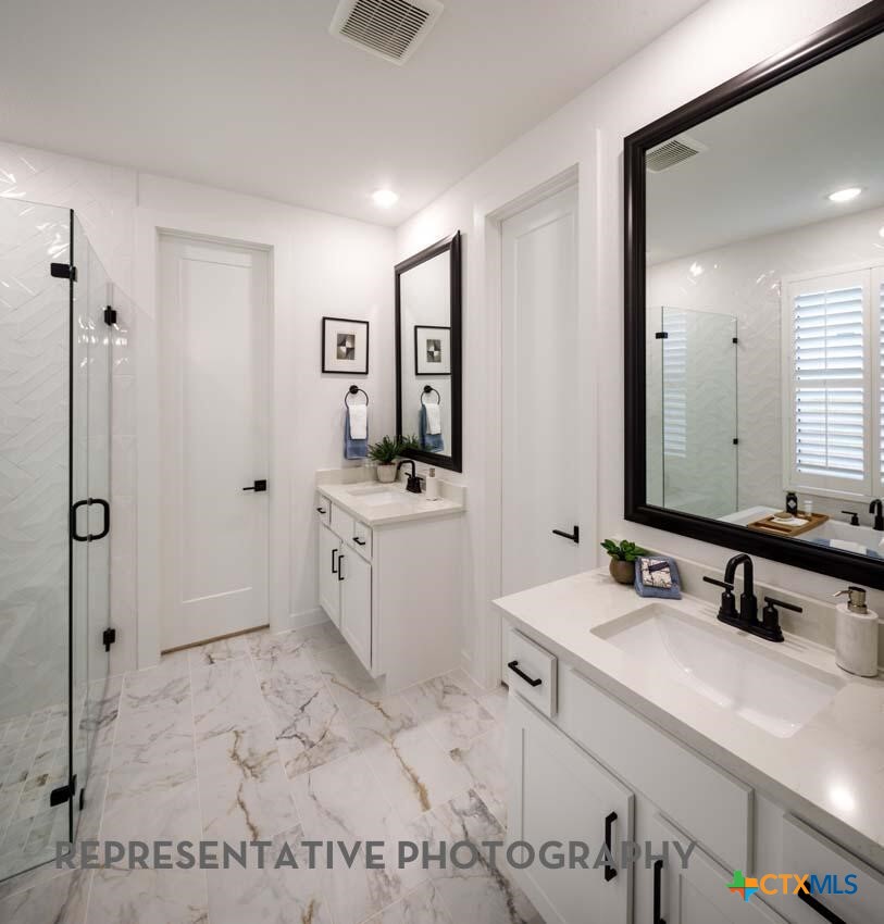 8808 Fallkill Drive Austin, TX 78744 - Photo 15 of 34 a spacious bathroom with a sink a mirror and a shower