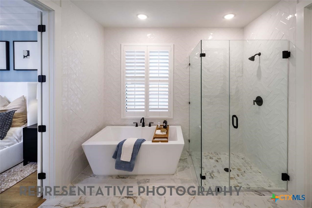 8808 Fallkill Drive Austin, TX 78744 - Photo 17 of 34 a spacious bathroom with a tub shower and window