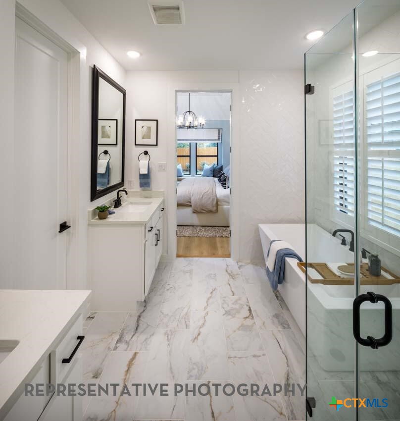 8808 Fallkill Drive Austin, TX 78744 - Photo 18 of 34 a bathroom with a tub sink and mirror