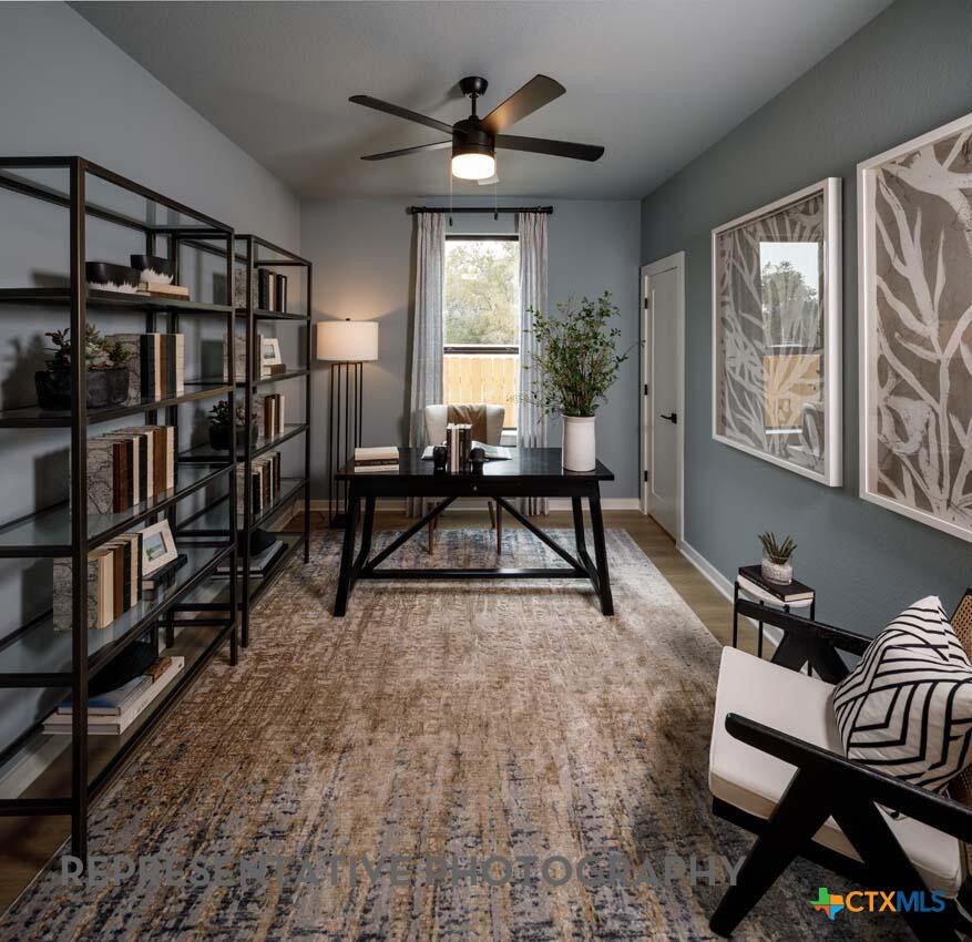 8808 Fallkill Drive Austin, TX 78744 - Photo 19 of 34 a living room with furniture a bookshelf and a window