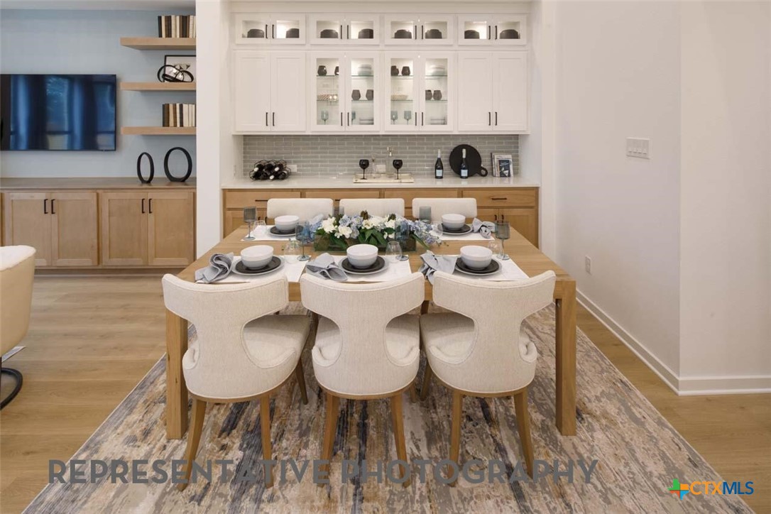 8808 Fallkill Drive Austin, TX 78744 - Photo 20 of 34 a view of a dining room with furniture and wooden floor