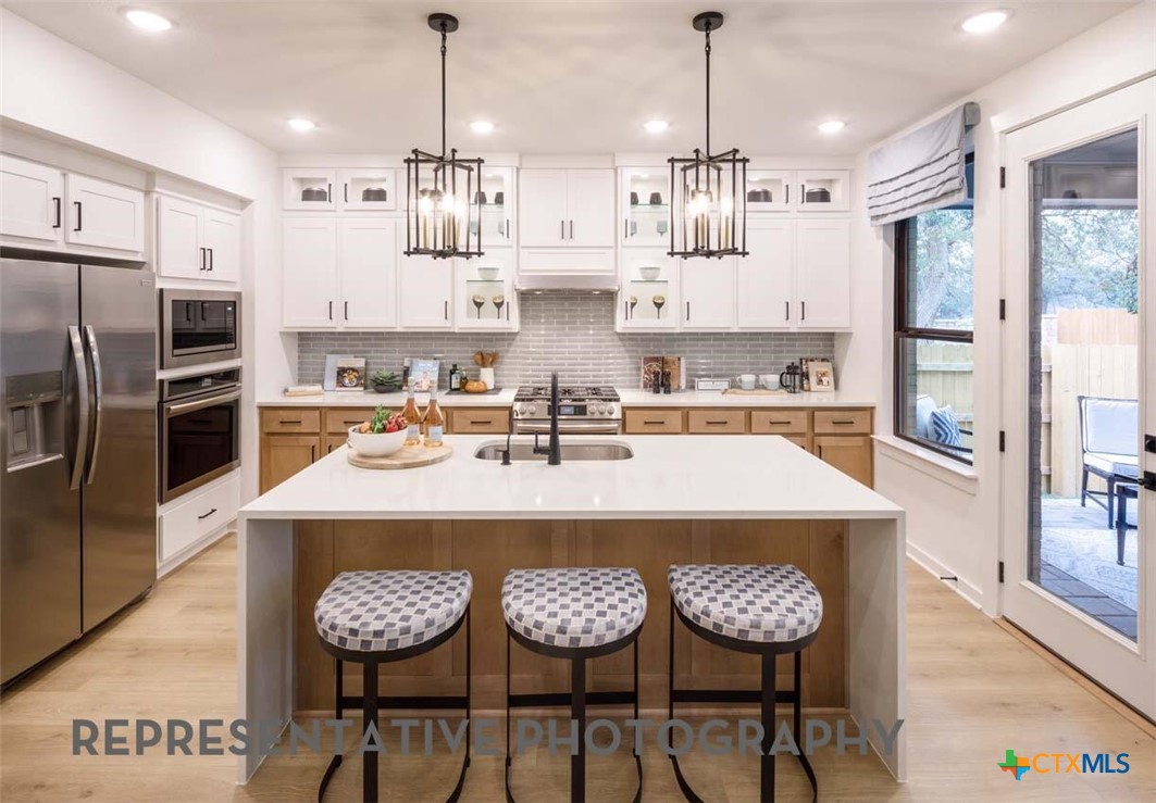 8808 Fallkill Drive Austin, TX 78744 - Photo 2 of 34 a kitchen with stainless steel appliances granite countertop a sink refrigerator and cabinets