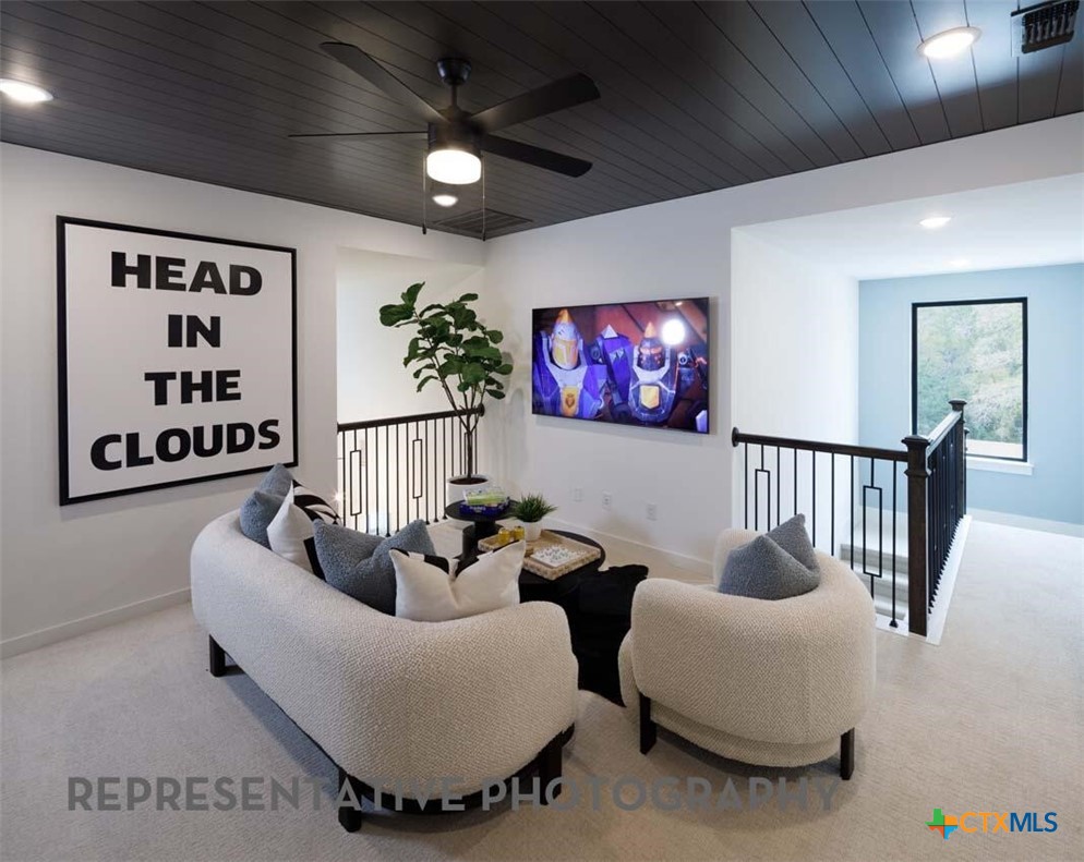 8808 Fallkill Drive Austin, TX 78744 - Photo 26 of 34 a living room with furniture and a flat screen tv