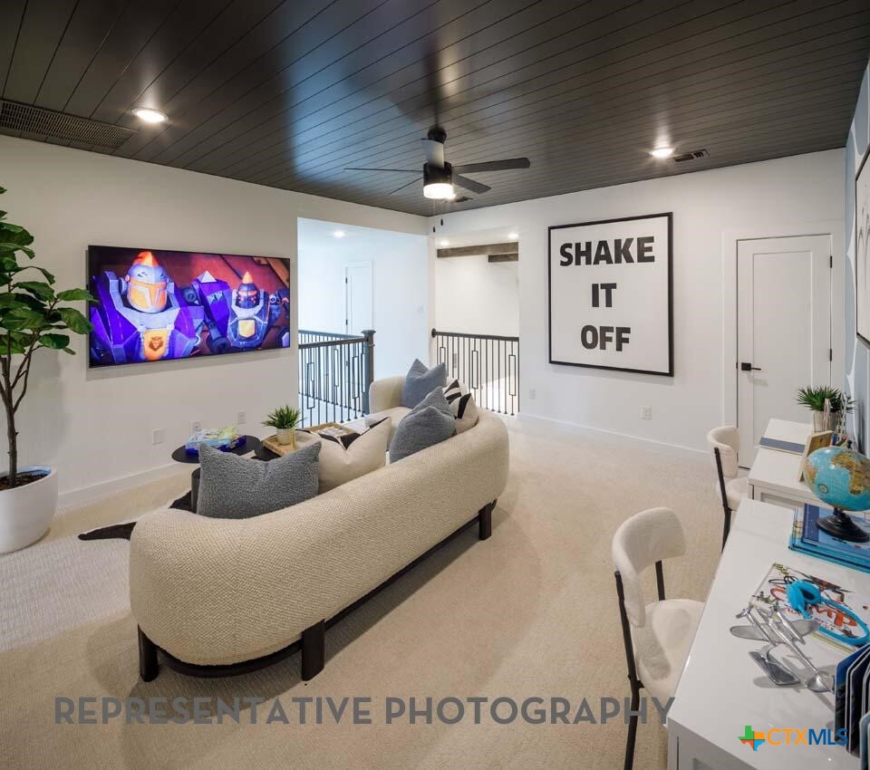 8808 Fallkill Drive Austin, TX 78744 - Photo 27 of 34 a living room with furniture and a flat screen tv