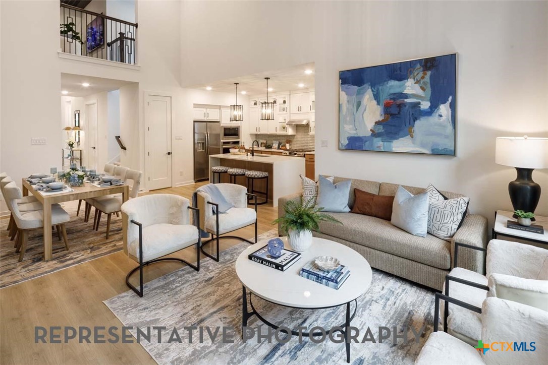 8808 Fallkill Drive Austin, TX 78744 - Photo 3 of 34 a living room with furniture and a dining table with kitchen view