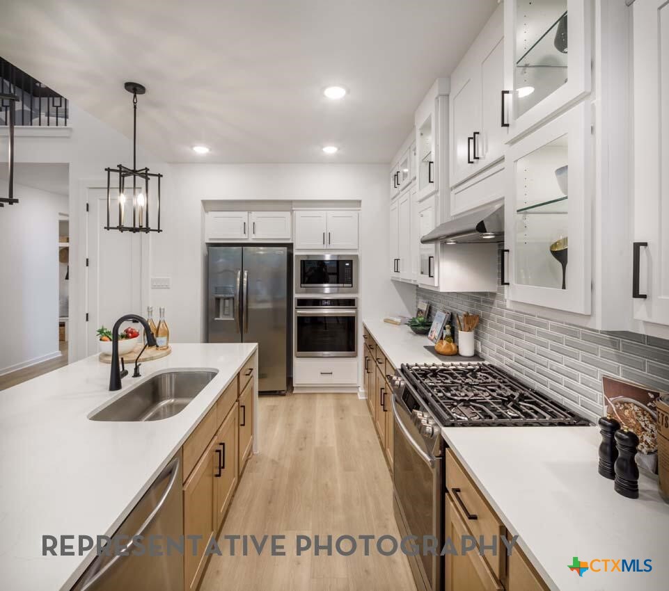 8808 Fallkill Drive Austin, TX 78744 - Photo 5 of 34 a kitchen with refrigerator and stove