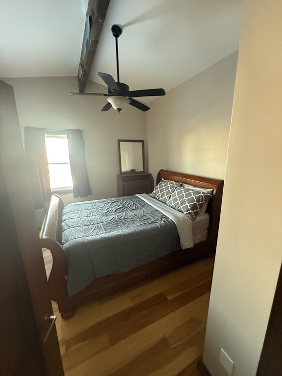271 Central Avenue Scituate, MA 02050 - Photo 8 of 18 a bedroom with a bed and a chandelier