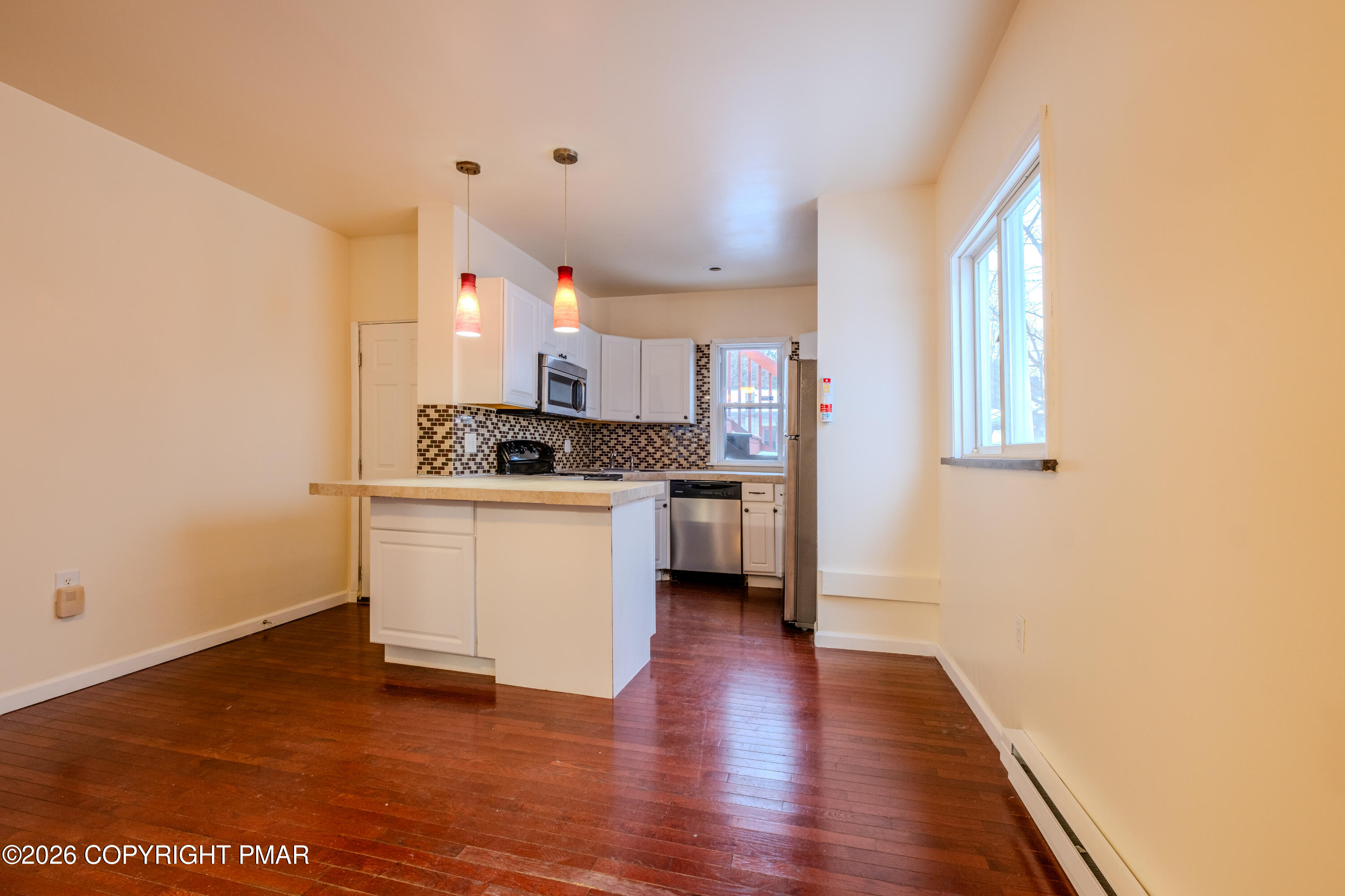 1042 Taylor Avenue Scranton, PA 18510 - Photo 16 of 40 a kitchen with granite countertop a stove a sink and a refrigerator