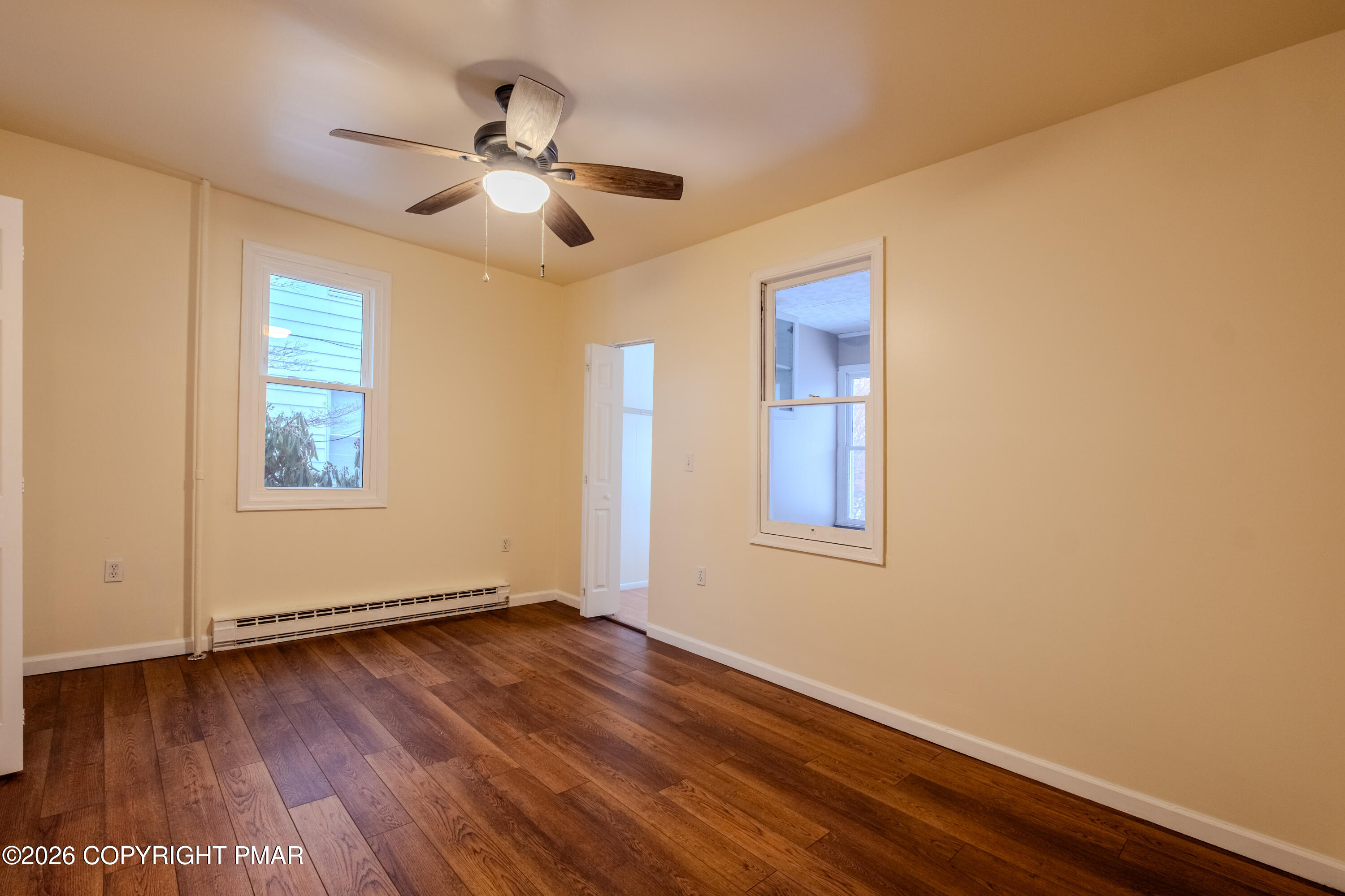 1042 Taylor Avenue Scranton, PA 18510 - Photo 19 of 40 a view of empty room with wooden floor and fan