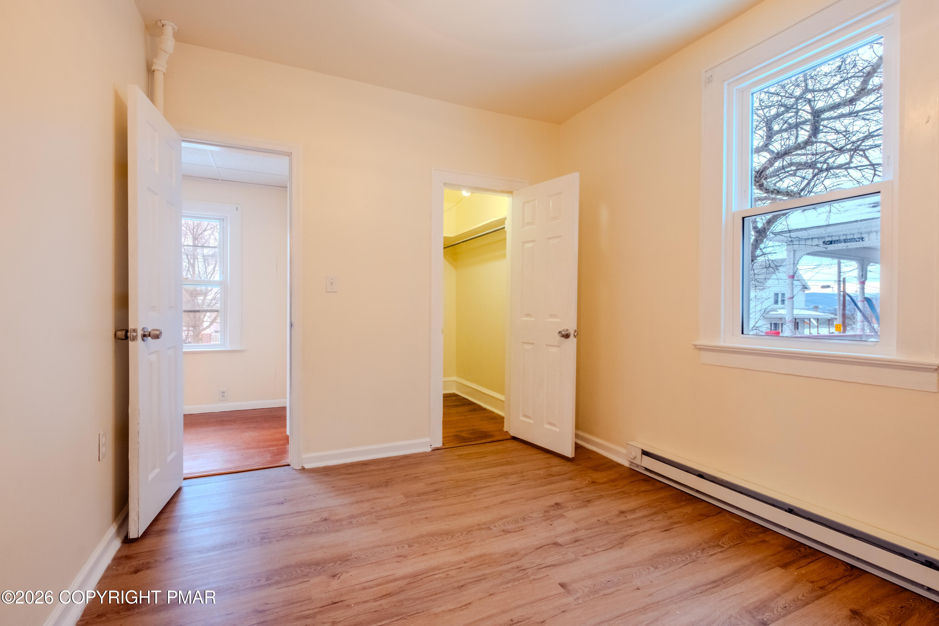 1042 Taylor Avenue Scranton, PA 18510 - Photo 22 of 40 an empty room with wooden floor and a window