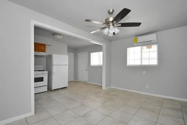 an empty room with closet and windows