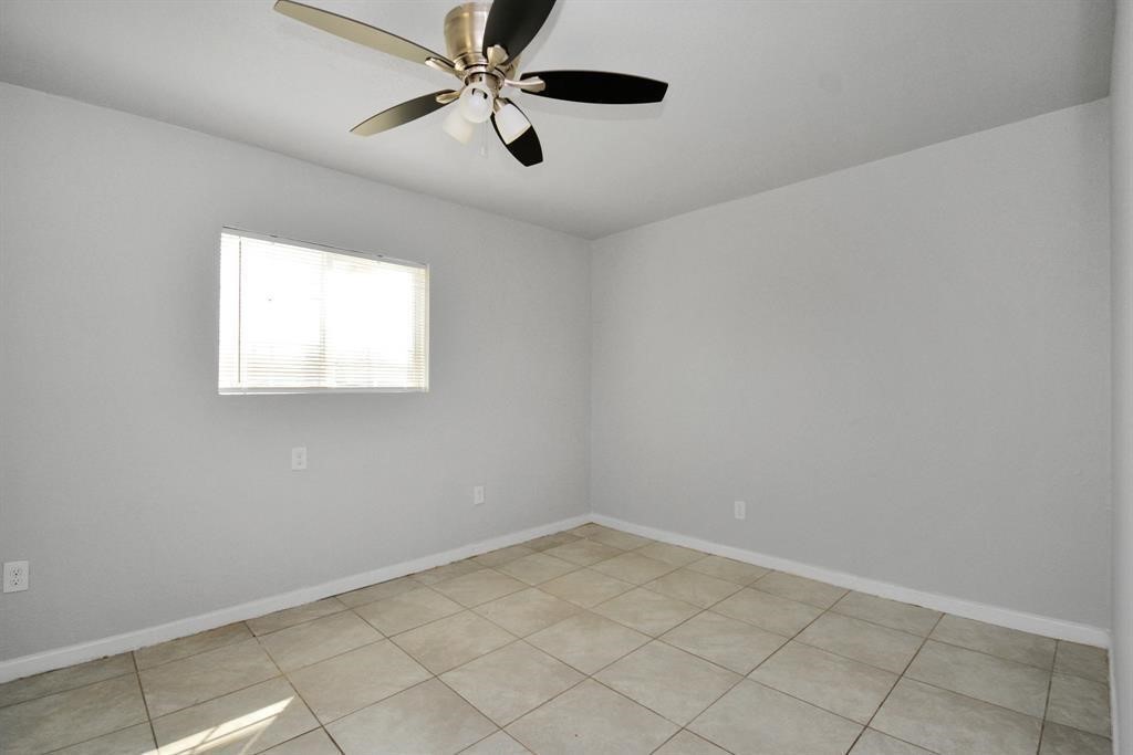 8127 Colonial Lane, Unit 2 Houston, TX 77051 - Photo 6 of 11 an empty room with a window and a fan