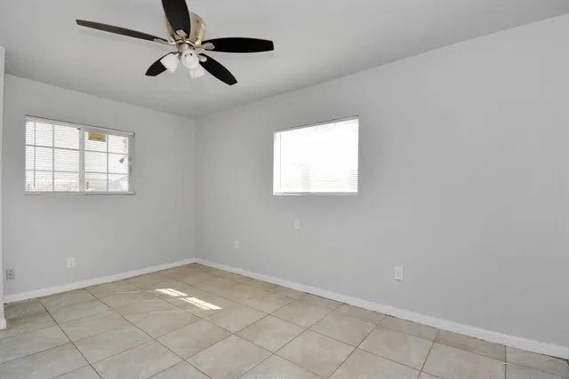 a view of empty room with ceiling fan