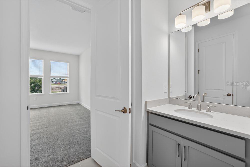 13505 Commons Avenue Parrish, FL 34219 - Photo 14 of 40 a bathroom with a sink a vanity and a mirror