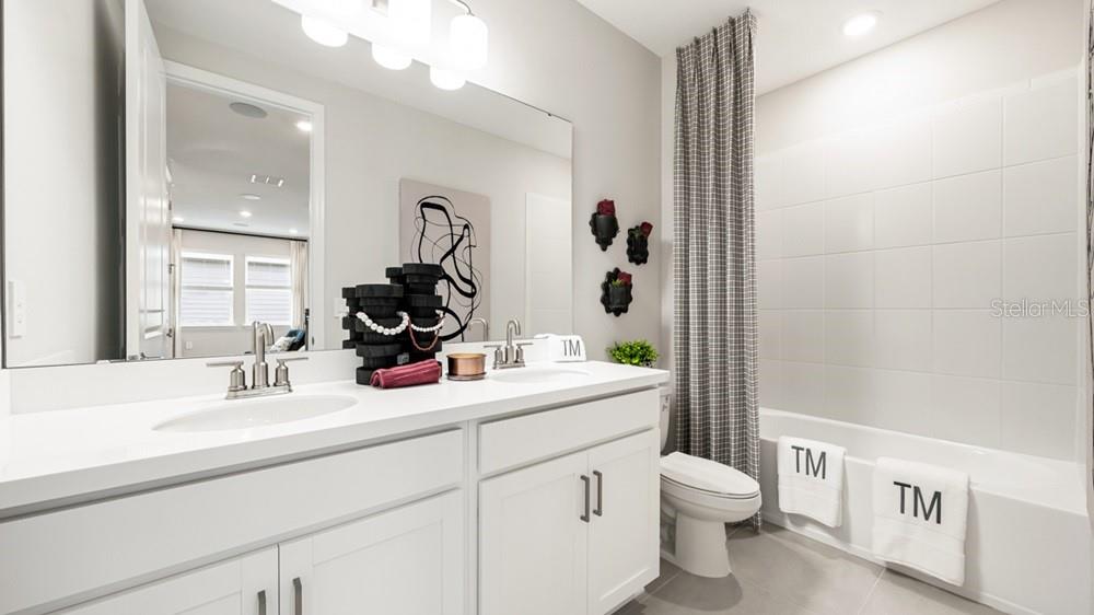 13505 Commons Avenue Parrish, FL 34219 - Photo 21 of 26 a bathroom with a toilet a sink and a mirror