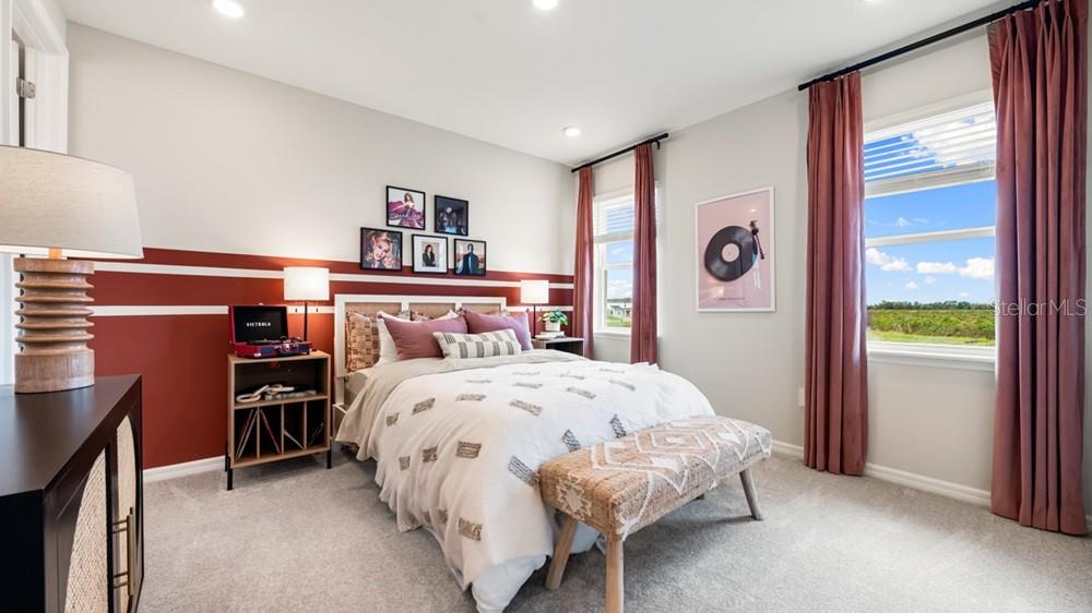 13505 Commons Avenue Parrish, FL 34219 - Photo 22 of 26 a bedroom with a bed and a large window