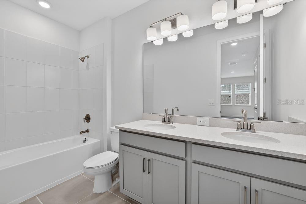 13505 Commons Avenue Parrish, FL 34219 - Photo 22 of 40 a bathroom with a sink a toilet and a large mirror