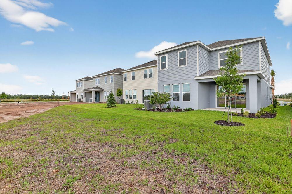 13505 Commons Avenue Parrish, FL 34219 - Photo 30 of 40 a view of a house with backyard and garden