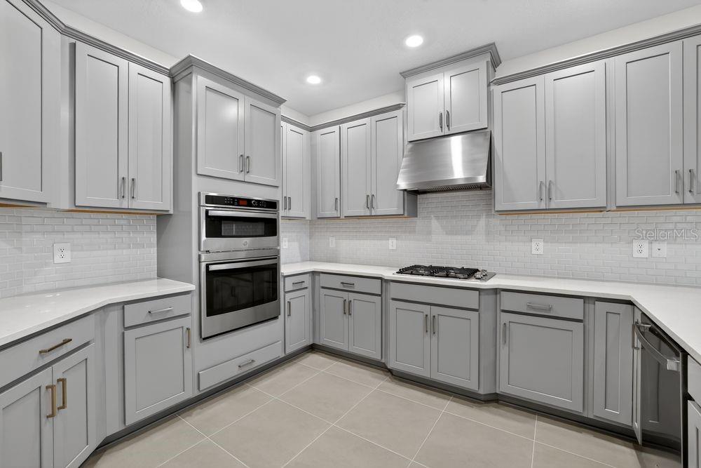 13505 Commons Avenue Parrish, FL 34219 - Photo 4 of 40 a kitchen with granite countertop white cabinets and stainless steel appliances
