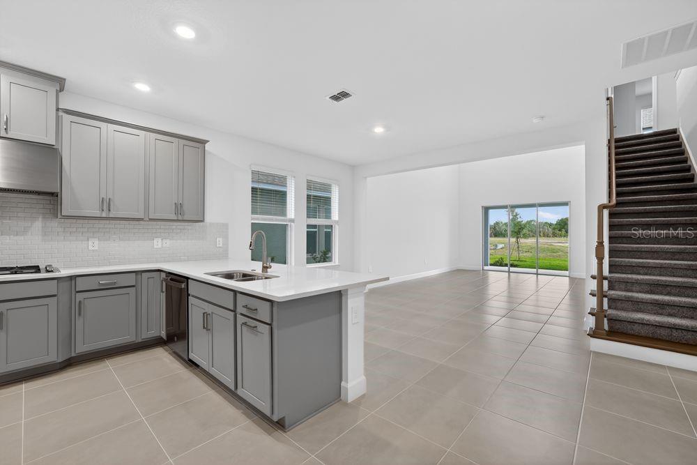 13505 Commons Avenue Parrish, FL 34219 - Photo 6 of 40 a kitchen with a stove and a kitchen island