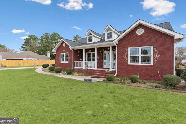 a front view of a house with a yard