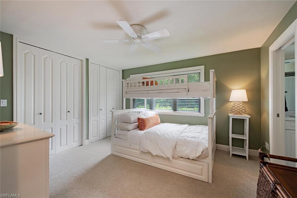 691 Ketch Drive Naples, FL 34103 - Photo 13 of 16 a bedroom with a bed and a table